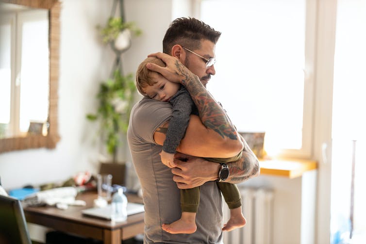 Man holding baby boy in his arms